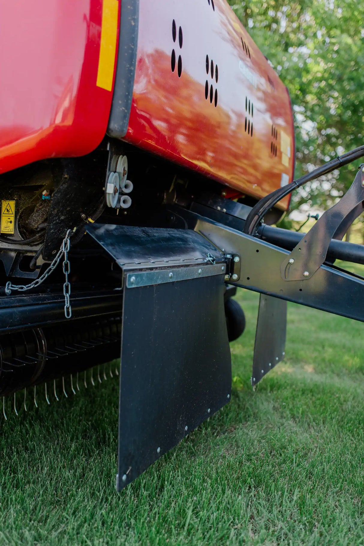 Close-up of a Case baler with a Rock Block on grass
