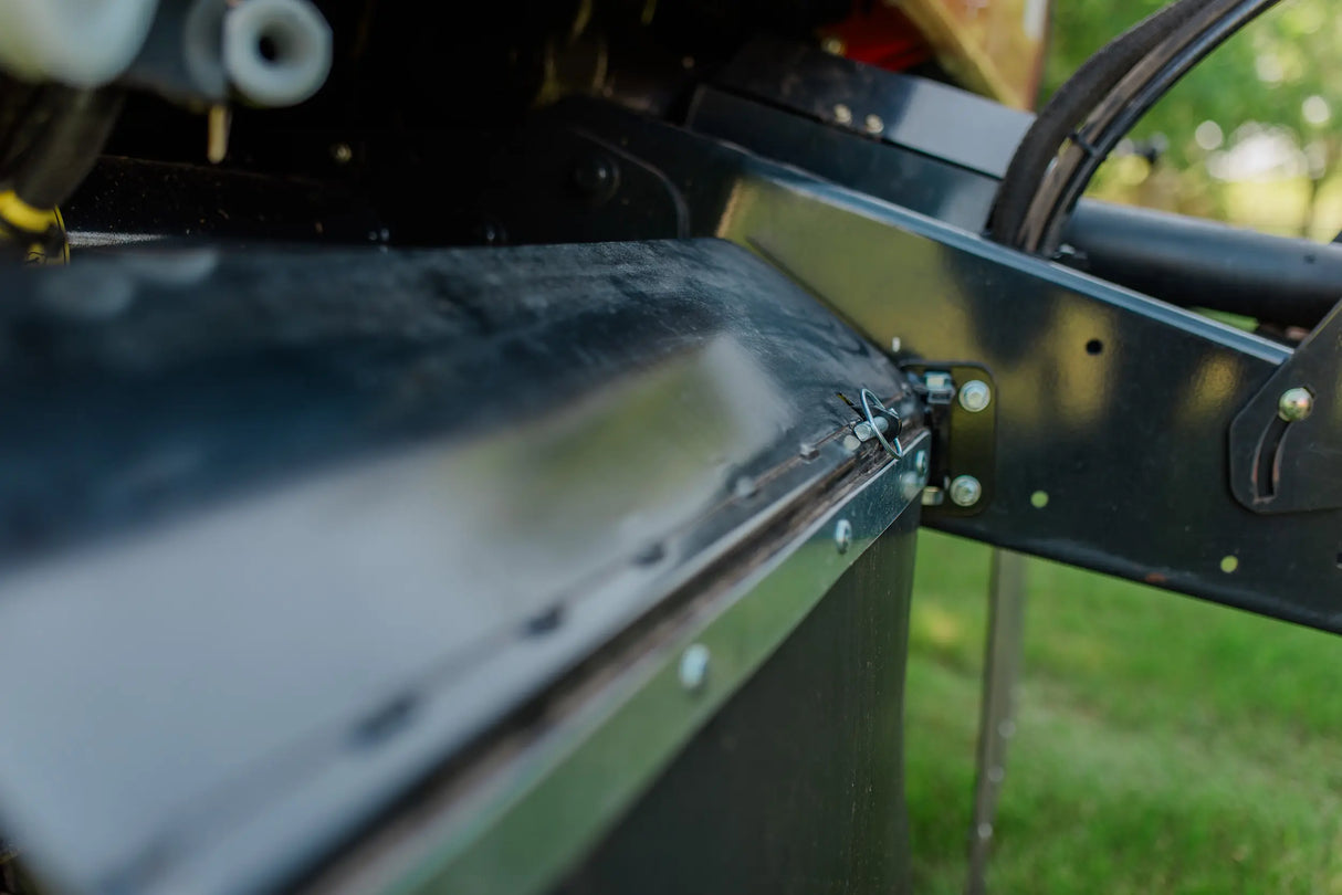 Close-up of a rock block on a baler with grass in the background