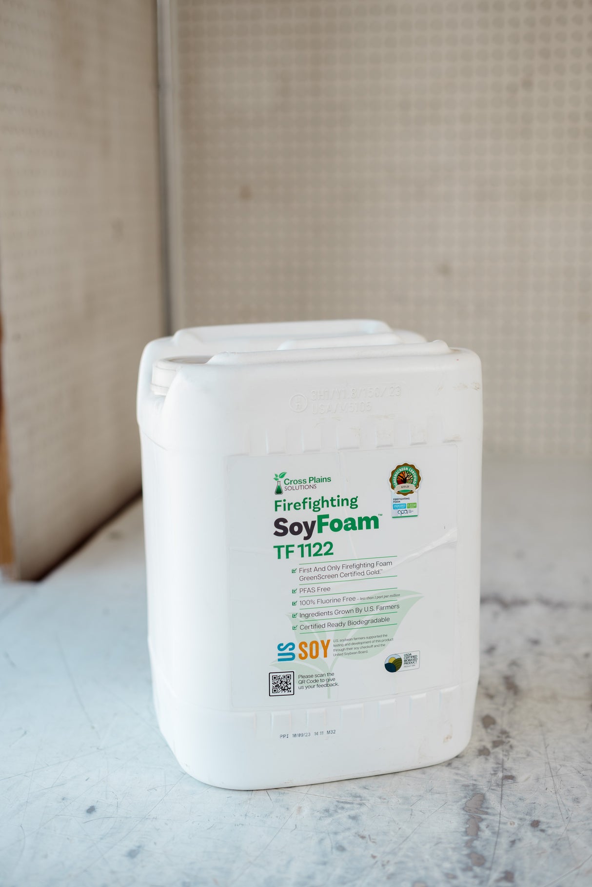 Container of firefighting soy foam on a textured surface