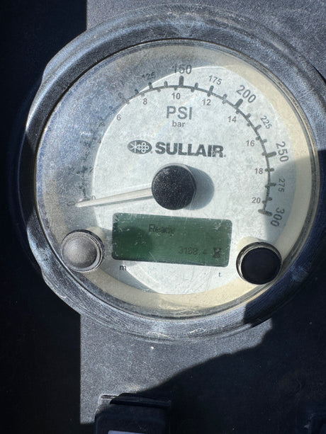 A close-up of a Sullair PSI gauge