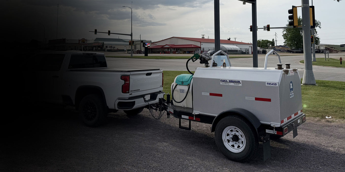 White pickup truck towing a Duo LIft Fuel Hauler trailer.