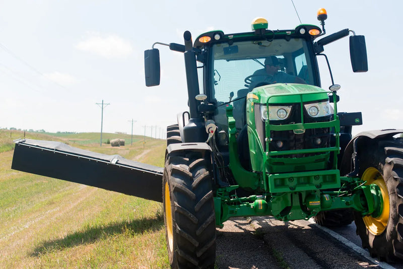 Tractor with hay cutter and The Rock Block installed