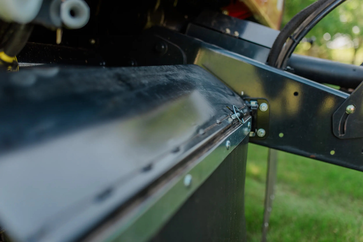 Close-up of a rock block on a baler with grass in the background